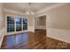Cozy living room features hardwood floors, lots of natural light, and wainscoting at 2835 Peverell Ln, Charlotte, NC 28270