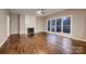 Inviting living room featuring a fireplace, hardwood floors, and large windows at 2835 Peverell Ln, Charlotte, NC 28270