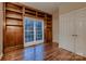 Office features hardwood floors, a large window, and a built-in bookshelf at 2835 Peverell Ln, Charlotte, NC 28270