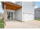 Backyard patio with wood pergola and string lights, attached two-car garage, perfect for outdoor entertaining at 3017 Woodlands Creek Dr, Monroe, NC 28110