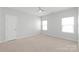 Bright bedroom featuring neutral walls, carpet flooring, windows, and a ceiling fan at 3017 Woodlands Creek Dr, Monroe, NC 28110