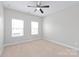 Bright bedroom featuring neutral walls, carpet flooring, and windows that flood the space with natural light at 3017 Woodlands Creek Dr, Monroe, NC 28110