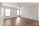 Bright bonus room features hardwood floors, neutral walls, a ceiling fan, and multiple windows at 3017 Woodlands Creek Dr, Monroe, NC 28110