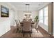 Elegant dining room with stylish chairs, modern lighting, and a decorative rug at 3017 Woodlands Creek Dr, Monroe, NC 28110