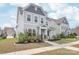 Charming two-story home with light blue siding, landscaped front yard, and inviting entrance at 3017 Woodlands Creek Dr, Monroe, NC 28110