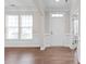 Bright foyer features hardwood floors, white trim, wainscoting, and a view to the entry door at 3017 Woodlands Creek Dr, Monroe, NC 28110