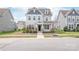Traditional two-story home boasts well-kept landscaping, a covered entryway, and light gray exterior at 3017 Woodlands Creek Dr, Monroe, NC 28110