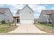 Rear home view with two-car garage and wooden pergola patio area provides functionality and aesthetic appeal at 3017 Woodlands Creek Dr, Monroe, NC 28110