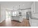 Bright kitchen boasts white cabinets, granite countertops, stainless appliances, and sliding glass doors to the backyard at 3017 Woodlands Creek Dr, Monroe, NC 28110