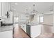 Modern kitchen featuring white cabinetry, granite countertops, stainless steel appliances, and pendant lighting at 3017 Woodlands Creek Dr, Monroe, NC 28110