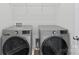 Efficient laundry room featuring side by side washer and dryer units with overhead shelving, ideal for storage at 3017 Woodlands Creek Dr, Monroe, NC 28110