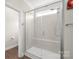 Modern bathroom shower with tile surround, glass door, and built-in seat offers a luxurious experience at 3017 Woodlands Creek Dr, Monroe, NC 28110