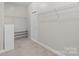 Walk-in closet providing ample storage space with shelving, a rack for shoes, and carpet flooring at 3017 Woodlands Creek Dr, Monroe, NC 28110
