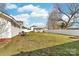 Spacious backyard with white fence offers privacy and open area with a shed in the background at 308 W First St, Lowell, NC 28098