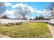A wide open backyard with white fencing and raised garden beds offers lots of space at 308 W First St, Lowell, NC 28098