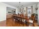 Traditional dining room with hardwood floors, decorative chandelier and large dark wood table with seating for eight at 308 W First St, Lowell, NC 28098