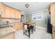 Eat-in kitchen featuring stainless steel appliances, custom cabinets and a breakfast bar island with seating at 308 W First St, Lowell, NC 28098