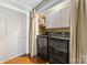 Modern laundry room with black washer and dryer, white cabinets, and ample storage space at 308 W First St, Lowell, NC 28098