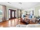 Living room with hardwood floors, fireplace, elegant front door, and access to the dining room at 308 W First St, Lowell, NC 28098