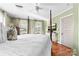 Bright and airy main bedroom with a four-poster bed, neutral colors and lots of light at 308 W First St, Lowell, NC 28098