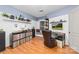 Stylish office space with hardwood floors, shelving, and a comfortable sitting area with record albums displayed at 308 W First St, Lowell, NC 28098