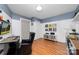 Well-lit office space with hardwood floors, record albums and decorative elements throughout the room at 308 W First St, Lowell, NC 28098