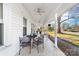 Extended front porch with multiple seating arrangements, ceiling fans, and lovely views at 308 W First St, Lowell, NC 28098