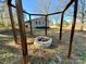 Fire pit area in the backyard with wood beams and exterior view of house at 3807 Woodlawn St, Sharon, SC 29742