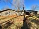 Wide backyard with fire pit area and the house exterior featuring a brick chimney at 3807 Woodlawn St, Sharon, SC 29742