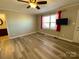 Brightly lit bedroom features a ceiling fan, plank floors, and neutral walls at 3807 Woodlawn St, Sharon, SC 29742