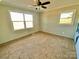 A brightly lit bedroom features new carpet, a ceiling fan, and neutral walls and trim at 3807 Woodlawn St, Sharon, SC 29742