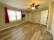 A brightly lit bedroom is furnished with plank floors, a ceiling fan, and a TV at 3807 Woodlawn St, Sharon, SC 29742