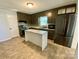 A full view of the kitchen featuring painted cabinets, stainless steel appliances, and white island at 3807 Woodlawn St, Sharon, SC 29742