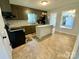 This kitchen features painted cabinets, stainless steel appliances, and an island with stone countertop at 3807 Woodlawn St, Sharon, SC 29742