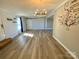 Spacious living room with wood-look floors, bright walls, and sliding barn door to another room at 3807 Woodlawn St, Sharon, SC 29742