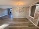 Bright living room with an open layout, decorative accent wall, and stylish wood-look floors at 3807 Woodlawn St, Sharon, SC 29742