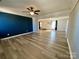 Spacious living room with wood-look floors, bright walls, and an open layout to adjacent rooms at 3807 Woodlawn St, Sharon, SC 29742