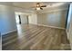 Spacious living room with wood-look floors, bright walls, and sliding barn door to another room at 3807 Woodlawn St, Sharon, SC 29742