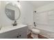 Bathroom with gray vanity, white countertop, round mirror, and shower with tub at 42 Magnolia St, York, SC 29745