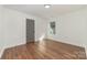 Bedroom featuring hardwood floors, white walls and trim, and one window at 42 Magnolia St, York, SC 29745