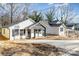 Charming home with white siding, black accents, and inviting front porch showing the well-lit entry at 42 Magnolia St, York, SC 29745