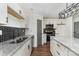 Well-lit kitchen with white cabinets, stainless appliances, and granite countertops for functionality at 42 Magnolia St, York, SC 29745