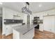 Modern kitchen featuring white cabinets, stainless appliances, and a granite island for functionality at 42 Magnolia St, York, SC 29745