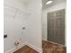 The laundry room is clean and equipped with wooden floors and a storage shelf at 42 Magnolia St, York, SC 29745