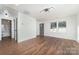 Inviting living room with wood floors and bright windows, showing the entry door and bathroom at 42 Magnolia St, York, SC 29745