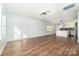 Open living area featuring wood floors and bright lighting connecting to the kitchen for modern appeal at 42 Magnolia St, York, SC 29745