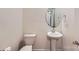 Clean powder room with a white pedestal sink, round mirror, and modern fixtures at 428 Nixon Rd, Belmont, NC 28012