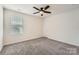 Bedroom featuring neutral carpet, a ceiling fan, and a window for natural light at 428 Nixon Rd, Belmont, NC 28012