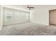Bright bedroom featuring neutral carpet, a ceiling fan, and multiple windows for natural light at 428 Nixon Rd, Belmont, NC 28012