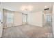 Spacious bedroom featuring large windows with draperies, modern lighting, and neutral carpeting at 428 Nixon Rd, Belmont, NC 28012